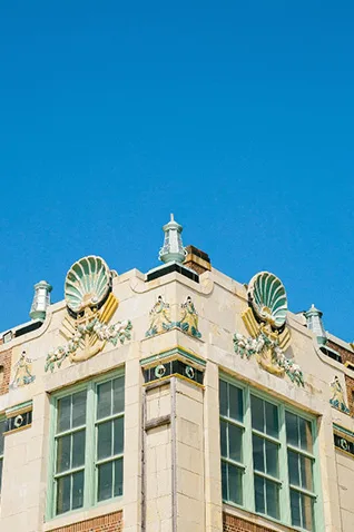 Historic architecture on the Asbury Park NJ boardwalk with seashell facade under blue sky
