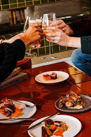 Things to do in Asbury Park NJ: Enjoy food and drinks at a local restaurant with music posters