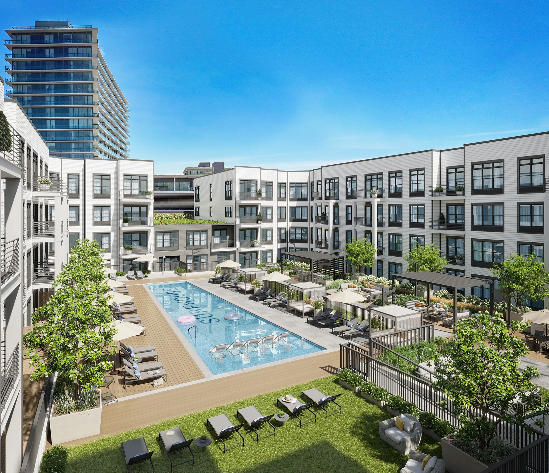Courtyard with pool and lounge seating framed by SURFHOUSE Asbury Park Apartments