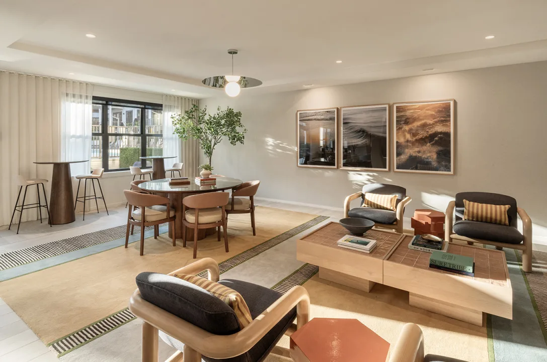 SURF HOUSE common area with modern lighting and plenty of comfortable seating options