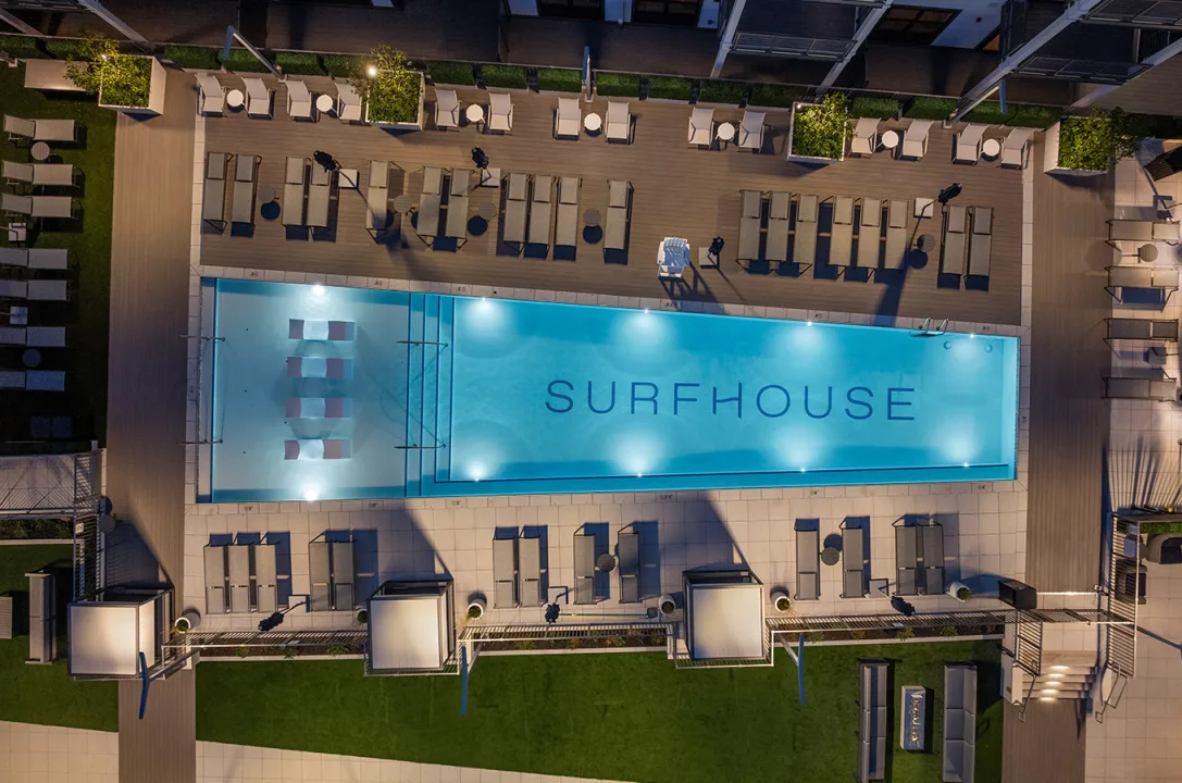 SURFHOUSE outdoor swimming pool and lounge area in Asbury Park: Aerial view at night.